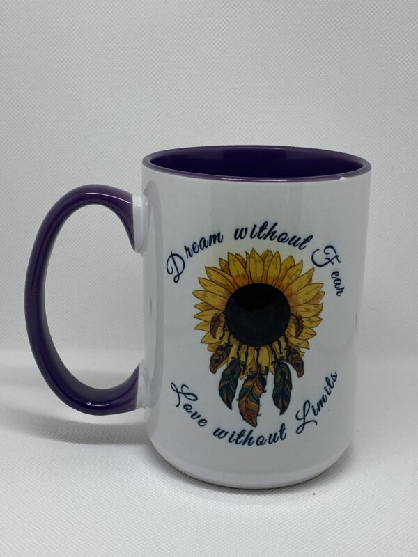 A coffee mug with the words " dream without fear, live without limits ".