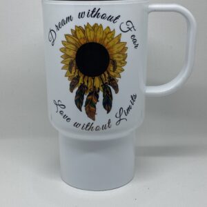 A white coffee mug with a sunflower and feathers.