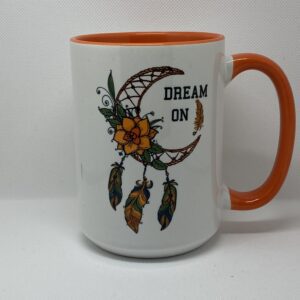 A coffee mug with the words " dream on ".