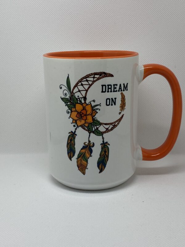 A coffee mug with the words " dream on ".