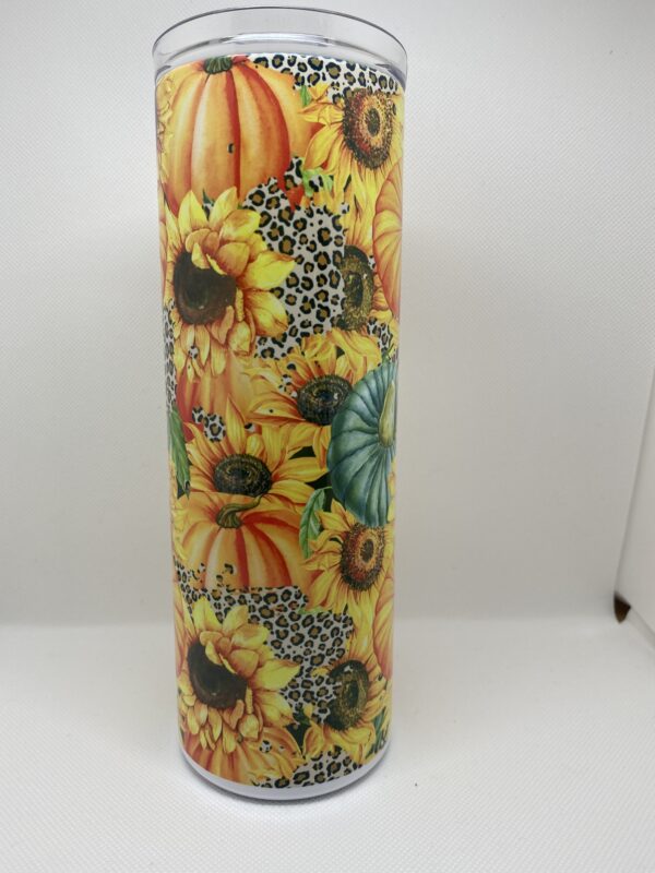 A tall vase with sunflowers and other flowers.