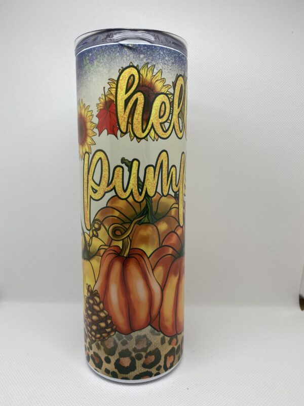 A candle that says hello pumpkin with pumpkins and leaves.