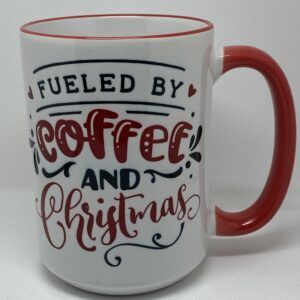 A coffee mug with the words fueled by coffee and christmas written on it.