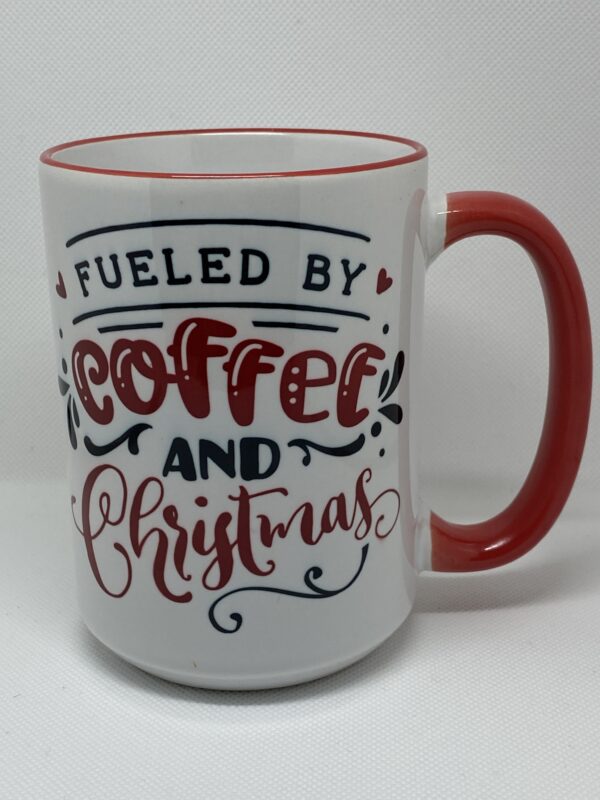 A coffee mug with the words fueled by coffee and christmas written on it.