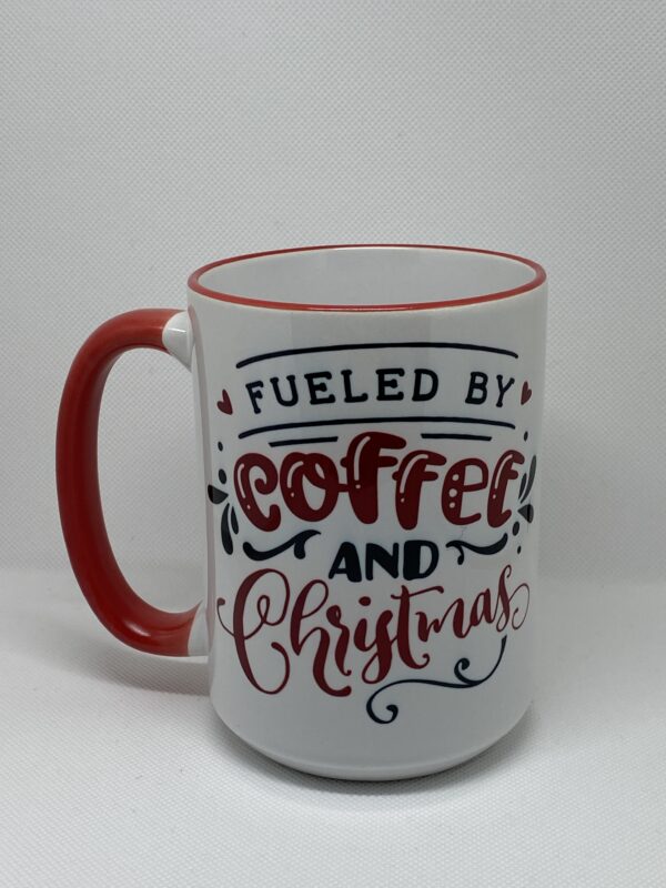 A coffee mug with the words fueled by coffee and christmas written on it.