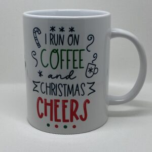 A coffee mug that says i run on christmas and coffee cheers.