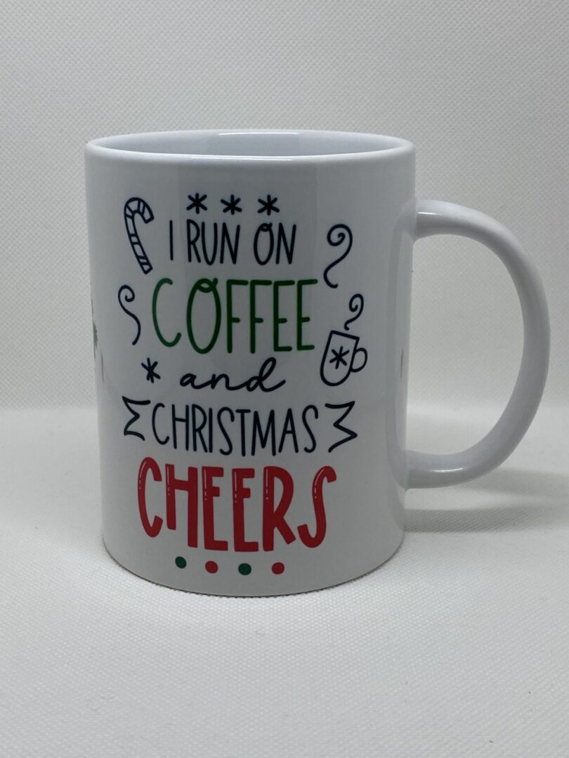 A coffee mug that says i run on christmas and coffee cheers.