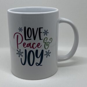 A white coffee mug with the words " love peace & joy ".