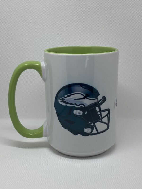 A green and white coffee mug with an image of a football helmet.