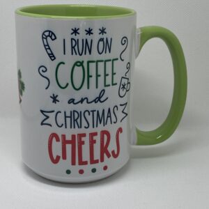 A coffee mug with the words " i run on coffee and christmas cheers ".