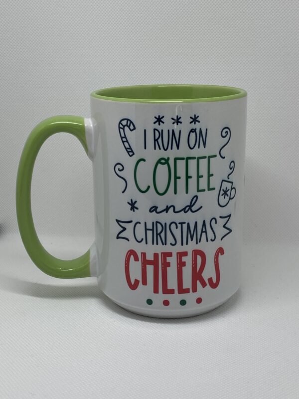 A coffee mug with the words " i run on coffee and christmas cheers ".