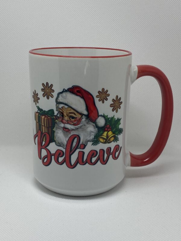 A coffee mug with santa claus and the words " believe ".