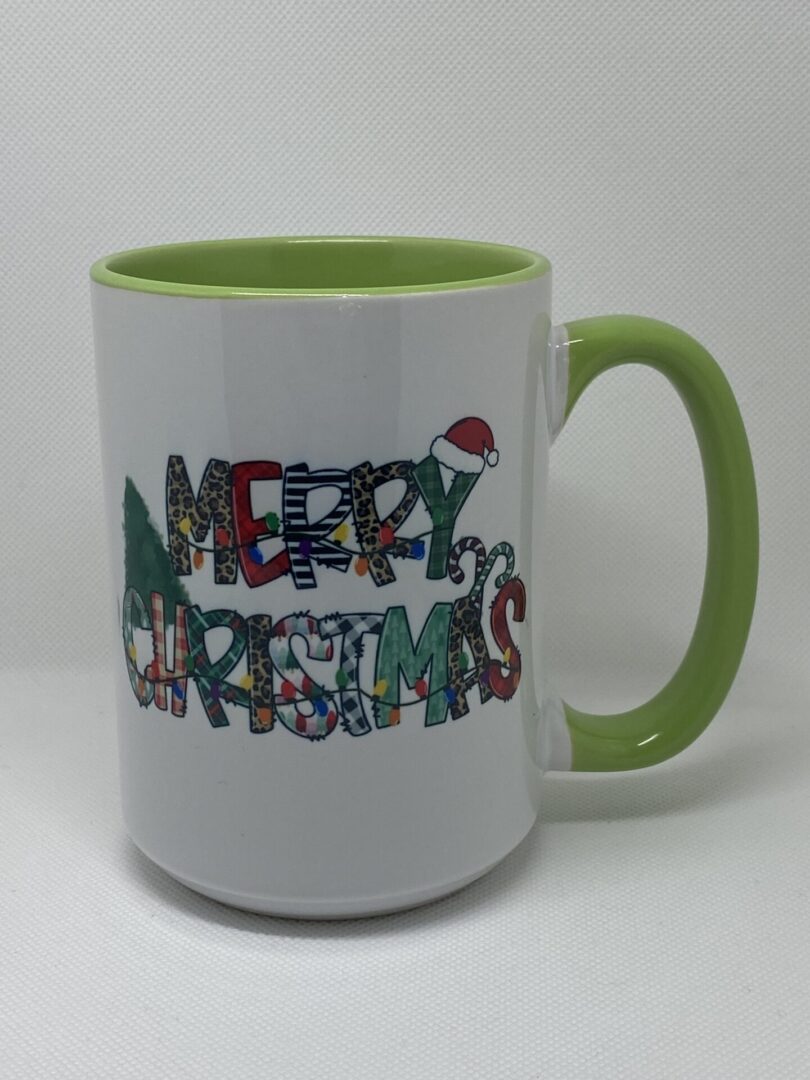 A green and white mug with the words merry christmas written in it.