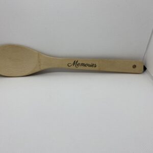 A wooden spoon with the word " memories " written on it.