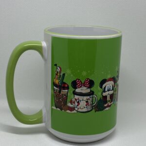 A green coffee mug with different characters on it.