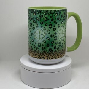 A green coffee mug sitting on top of a white box.