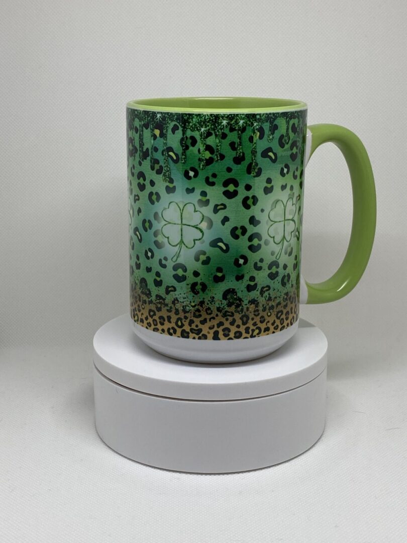 A green coffee mug sitting on top of a white box.