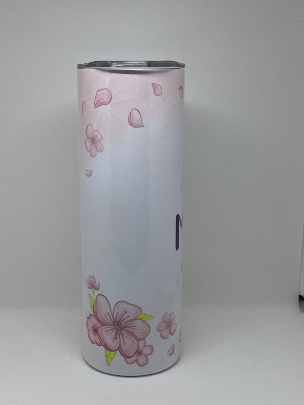 A tall white vase with pink flowers on it.