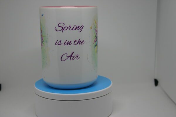 A cup that says spring is in the air